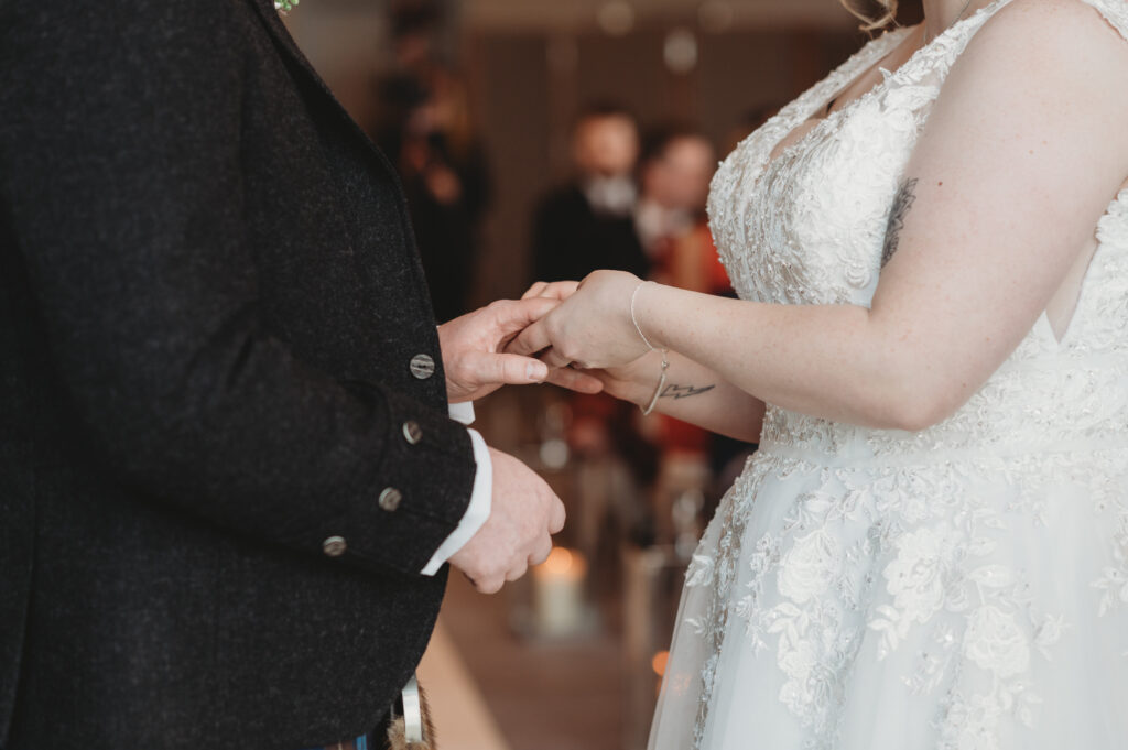 Bride and groom exchange rings at Meldrum house, aberdeenshire 