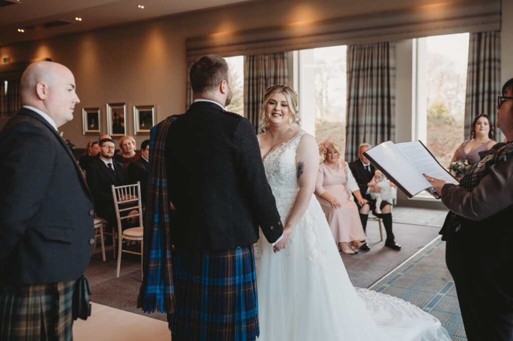 Bride and groom exchange rings at Meldrum house, aberdeenshire 