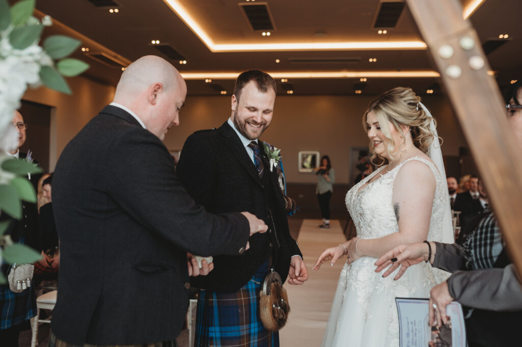 Bride and groom exchange rings at Meldrum house, aberdeenshire 