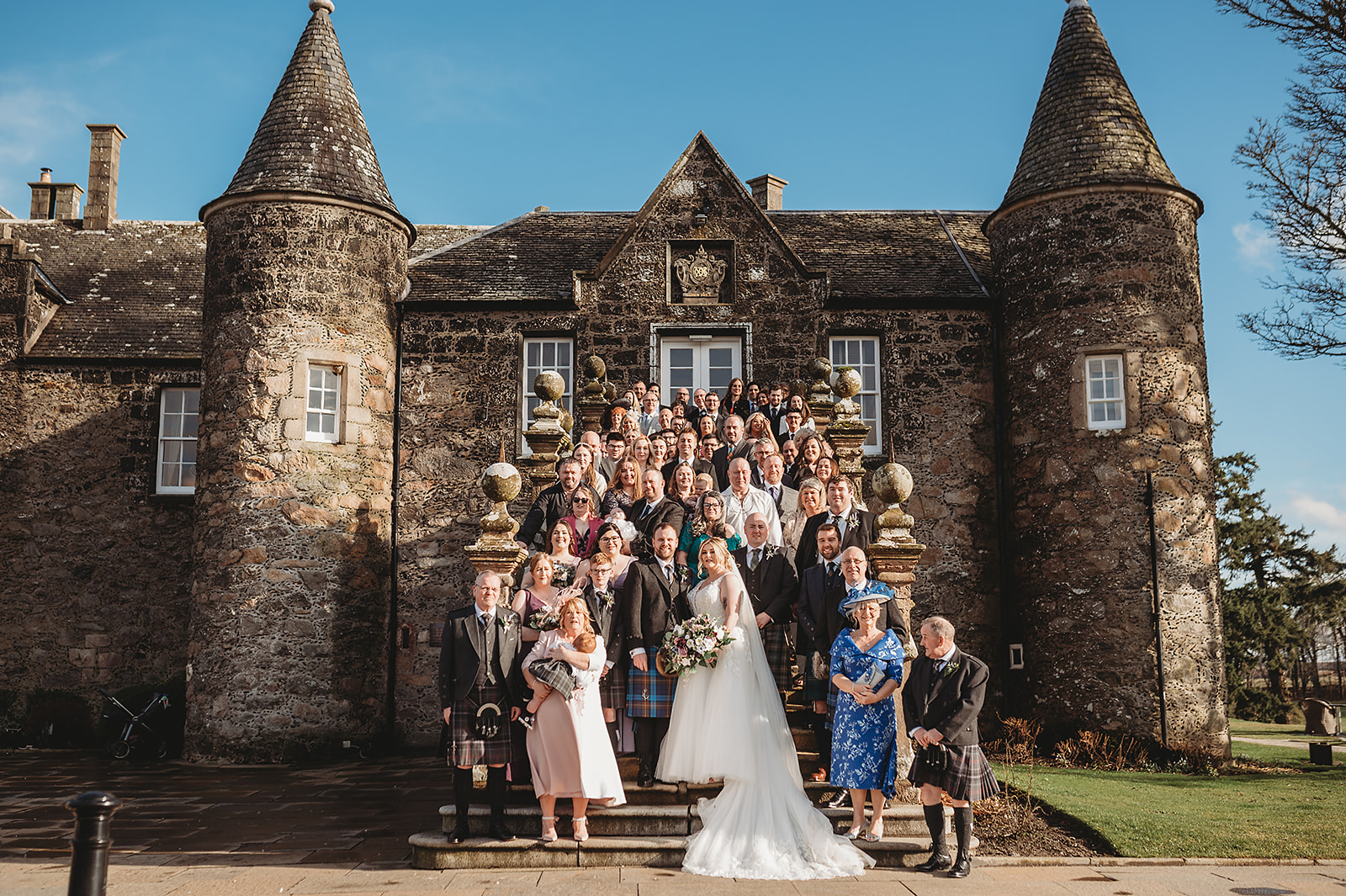 Wedding guests photographed on historic Aberdeenshire Wedding Venue Meldrum House steps during Aberdeenshire wedding