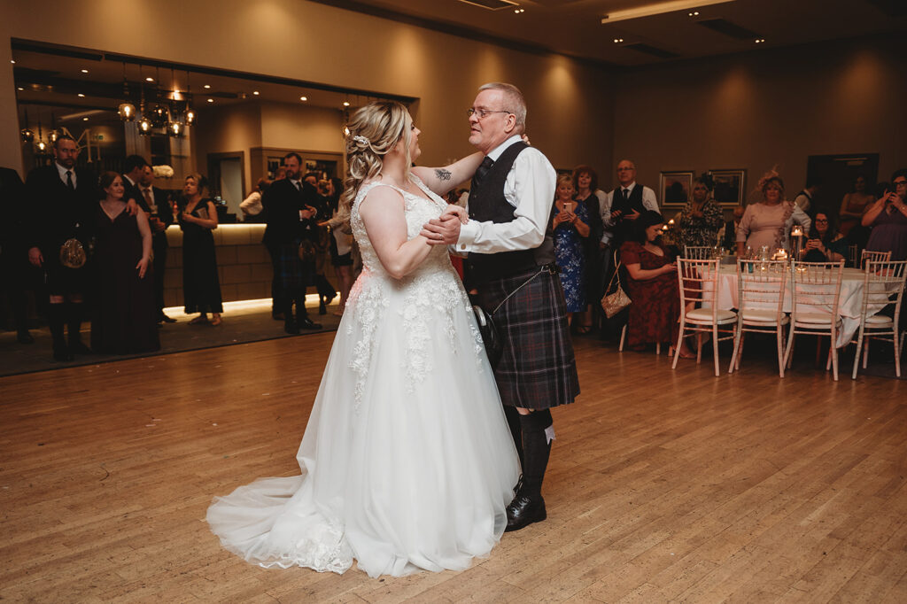 FAther daughter dance during Evening reception at meldrum house, aberdeenshire 