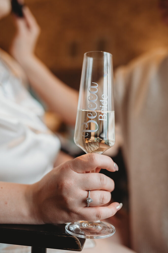 Bride holding champagne flute at Aberdeenshire venue Meldrum House