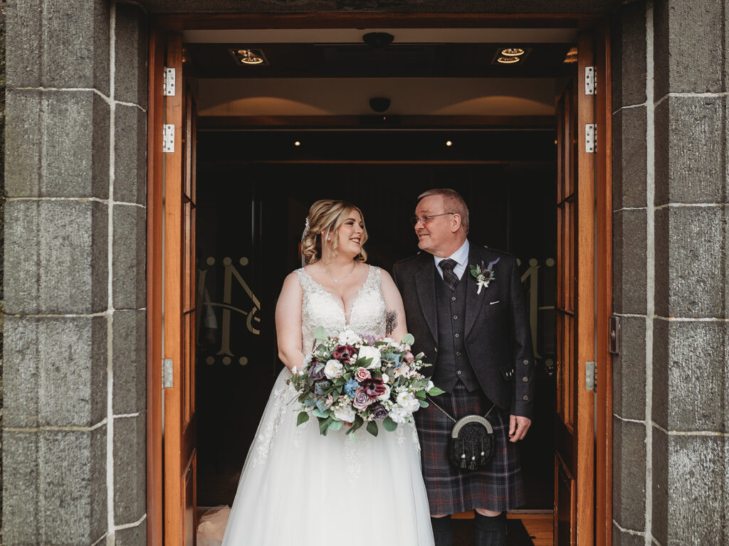 Aberdeenshire bride ready with Dad at main doors of Meldrum house, Aberdeenshire