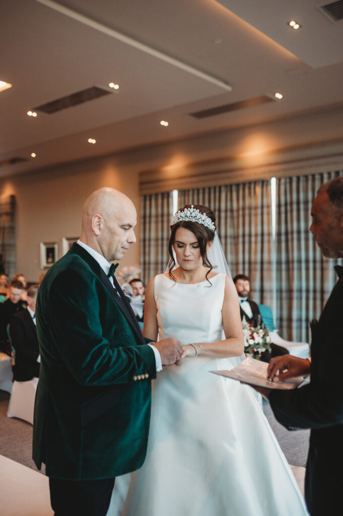 Bride and groom exchange rings at meldrum house aberdeenshire 
