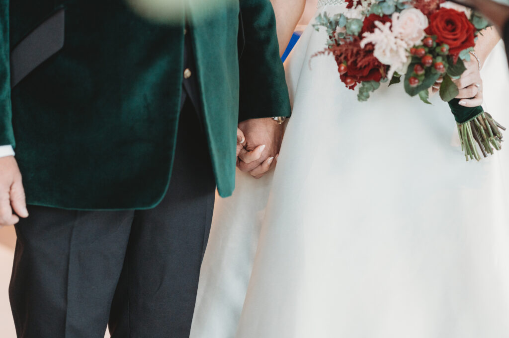 Bride and groom hold hands at meldrum house aberdeenshire 