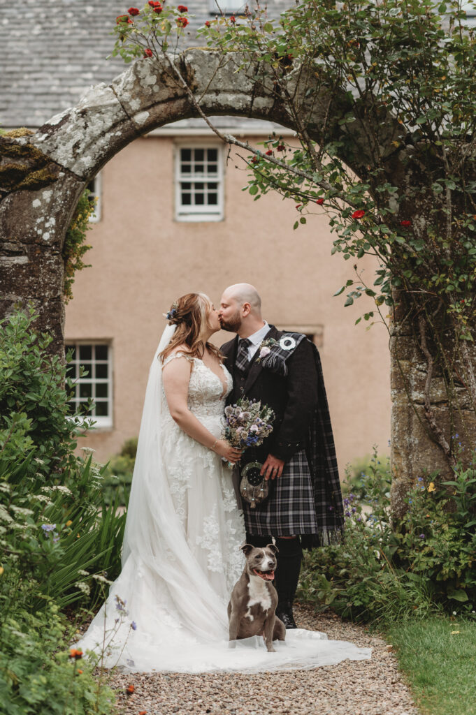 Aberdeenshire couple poses with their dog at their Aswanley wedding
