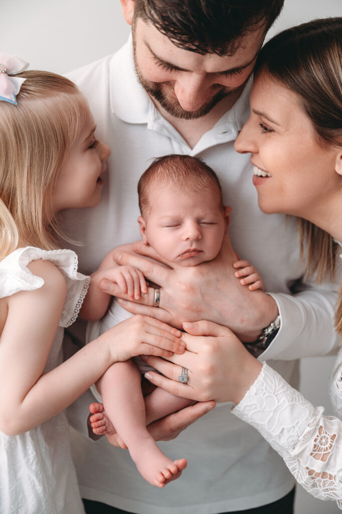 Family holds newborn baby during newborn session in Aberdeenshire