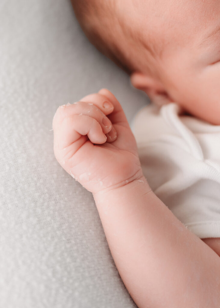 Close-up shot of the baby's hands during a newborn session in Aberdeenshire