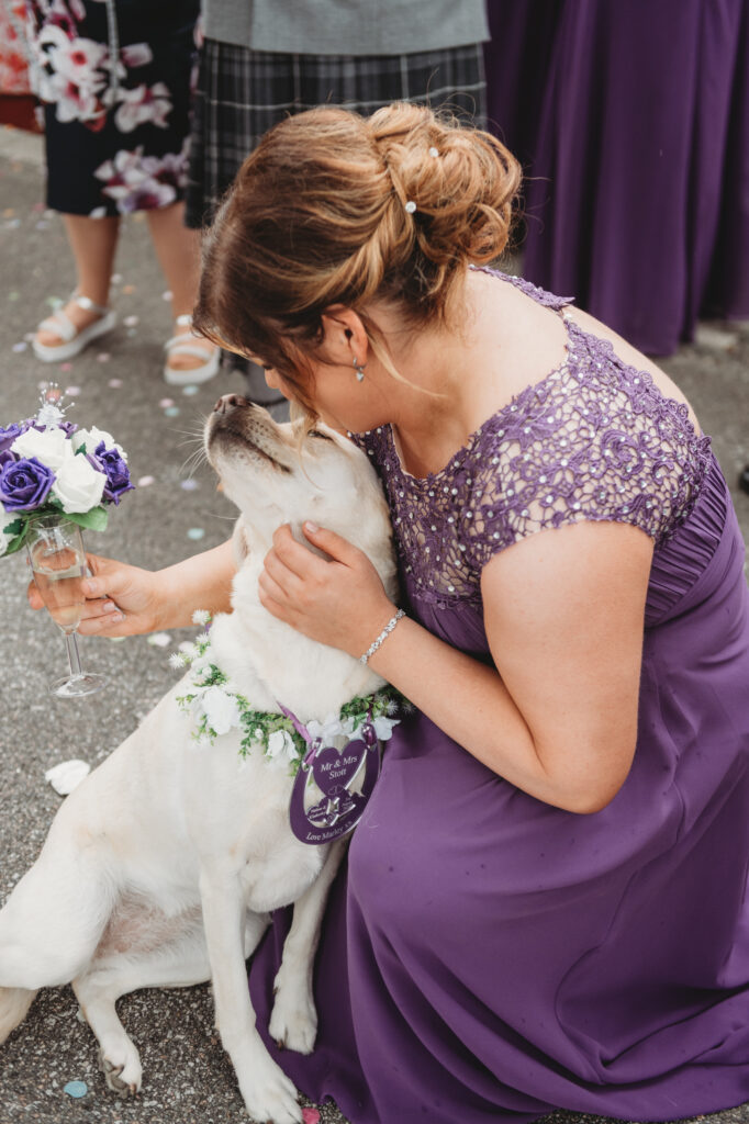 Candid shot with an Aberdeenshire bridesmaid and a dog at a Ban Car Hotel wedding