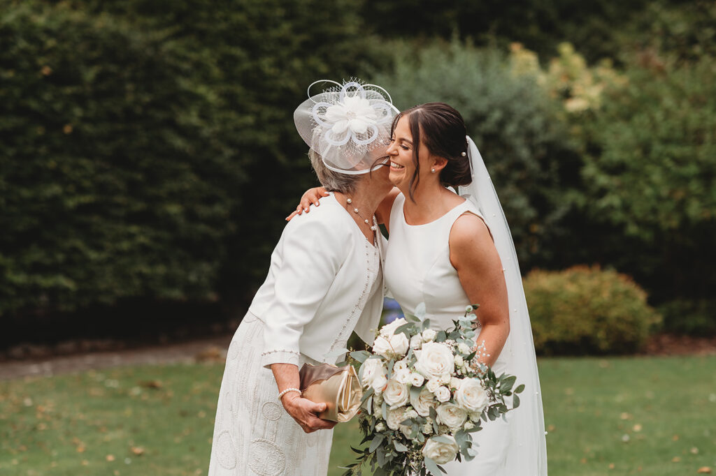 Aberdeenshire wedding photographer captures wedding family photo special hug at Marcliffe