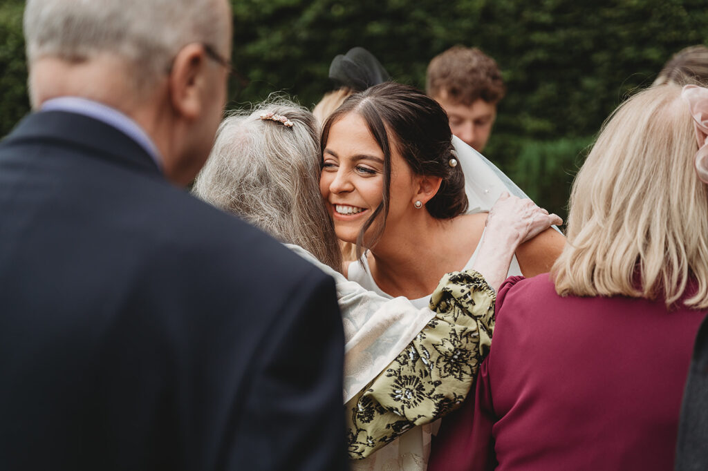 Aberdeenshire wedding photographer captures wedding family photo special hug at Marcliffe